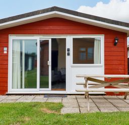 A cabin exterior with a picnic table at H2 Atlantic Bay Holiday Park in Padstow
