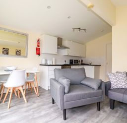 A kitchen with a dining table and chairs at H2 Atlantic Bay Holiday Park Padstow