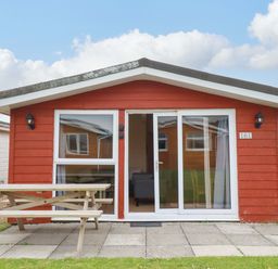 A cabin with a table and benches at 161 Atlantic Bay Holiday Park in Padstow