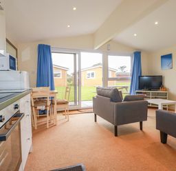 A living room with a sofa and dining area at 161 Atlantic Bay Holiday Park Padstow