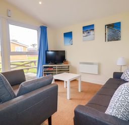 A living room with a sofa and coffee table at 161 Atlantic Bay Holiday Park in Padstow