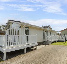A house with a deck and yard at Erisa in Stepaside