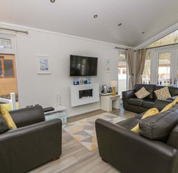 A living room with sofas and a television at Erisa in Stepaside