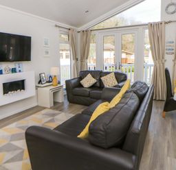 A living room with a television and sofa at Erisa in Stepaside