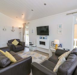 A living room with a television and sofas at Erisa in Stepaside