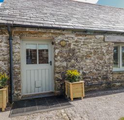 A front entrance with a door and planters at Roughtor Barn Poldue near Camelford