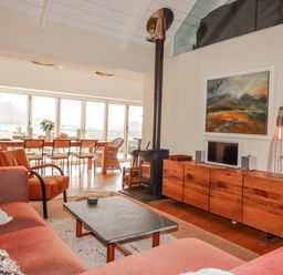 A living room with a sofa and coffee table at Roughtor Barn in Poldue near Camelford