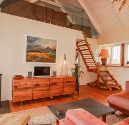 A living room with a wood stove and television at Roughtor Barn Poldue near Camelford