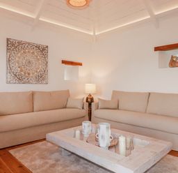 A living room with sofas and a coffee table at Logan Barn in Poldue near Camelford