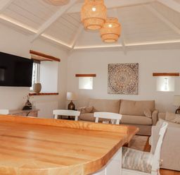 A living room with a sofa and television at Logan Barn near Camelford