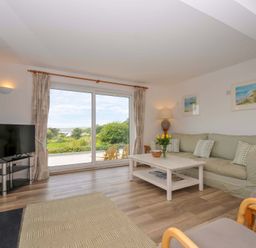 A living room with a sofa and coffee table at Seaworthy in Daymer Bay