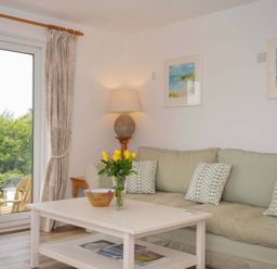 A living room with a couch and a coffee table at Seaworthy in Daymer Bay
