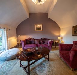A living room with a sofa, armchair and coffee table at 5 St. Michaels Close in Framlingham