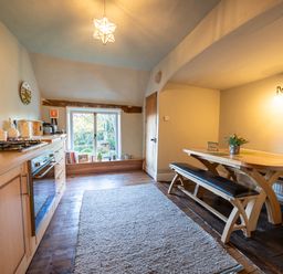 A kitchen with dining table and bench seating at 5 St. Michaels Close in Framlingham