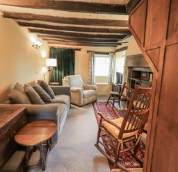 A living room with a sofa and rocking chair at Old Cottage in Oxen Park near Ulverston