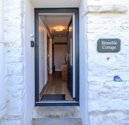 An entrance to Bramble Cottage with door open at Thornthwaite near Braithwaite