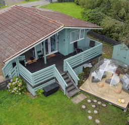 A house with a deck and outdoor furniture at Scarba Balvicar, Isle Of Seil
