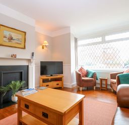 A living room with a sofa and coffee table at Highland House in Sheringham