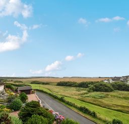 A view of houses and open fields at Seaddler in Trearddur Bay