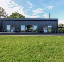 A house with large windows and a patio at Y Cwt Moelfre