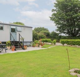 An outdoor area with a house-shaped structure and garden at Teg in Prospidnick near Porthleven