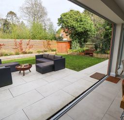 A garden patio with outdoor seating and a fire pit visible from the dining area at Natterjacks in Syderstone