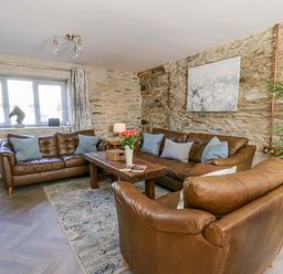 A living room with a sofa and a coffee table at La Bastille in Maenclochog
