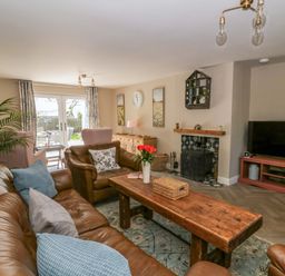 A living room with a coffee table and sofa at La Bastille in Maenclochog