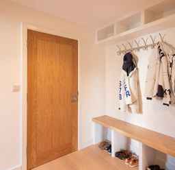 A hallway with a coat rack and shoes at Pentire in St Minver