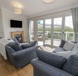 A living room with a television and sofas at Platinum Lodge (503) Talybont