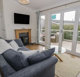 A living room with a sofa and coffee table at Platinum Lodge (503) Talybont
