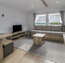 A living room with a sofa and coffee table at Lido Silver Plus 111 Prestatyn
