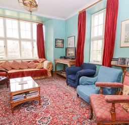 A sitting room with armchairs sofa coffee table and television at Plas Pontfaen near Fishguard and Newport Pembrokeshire