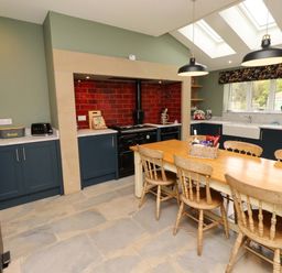 A kitchen featuring a dining table and oven at 9 Longhirst Village in Morpeth