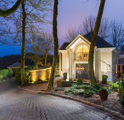 A driveway leading to a house entrance with columns and double doors at Hunters Moon in Charlestown