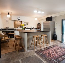 A kitchen with a fridge and counter at The Old Coach House in Eglingham near Alnwick
