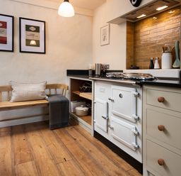 A kitchen with an oven, sink, and bench at The Old Coach House in Eglingham near Alnwick