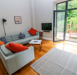 A living room with a sofa and coffee table at The Old Creamery in Ffairfach