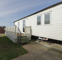A caravan with steps and railing in an outdoor area at Gold Caravan (203) Talybont