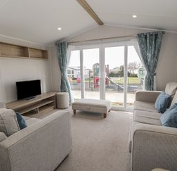 A living room with two sofas and a television at Gold Caravan (203) Talybont