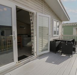 An outdoor area with a table and chairs at Gold Lodge (201) Talybont