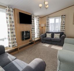 A living room with sofas and a TV at Gold Lodge (201) Talybont