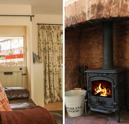 A brown leather sofa with cushions near a half door and floral curtains and a wood burning stove with a bucket labeled kindling wood and firewood at Little Dragons in Dunster near Minehead