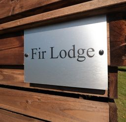 A sign displaying the name Fir Lodge