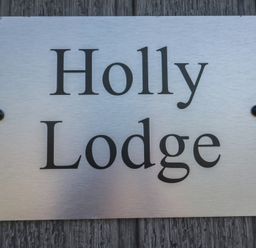 A nameplate reading Holly Lodge at Holly Lodge in Whitby