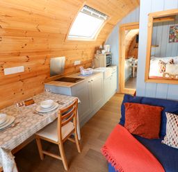 A kitchen with dining table and chairs at Ty Twt Teifi in Llanddewi-Brefi