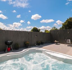 An outdoor area with a hot tub and grill at Number 7 in Bishop Sutton