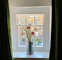 A window with flowers in a vase at Quarryman's cottage in Beddgelert