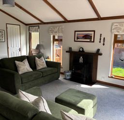 A living room with a sofa and television at 2 Riverside Lodge Abercych near Cenarth