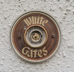 A nameplate fixed to a wall at White Gates in Banham